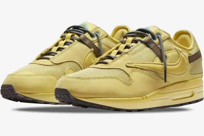 Nike Air Max 1 x Travis Scott Cactus Saturn Gold sneakers in yellow, three-quarter front view perspective. - SKU DO9392-700