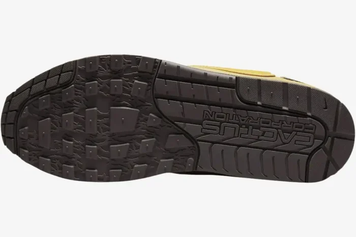 Bottom view of the Nike Air Max 1 x Travis Scott Cactus Saturn Gold shoe showing the brown textured outsole. - SKU DO9392-700