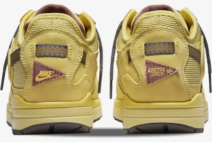 Rear view of Nike Air Max 1 x Travis Scott Cactus Jack sneakers in Saturn Gold with logo patches. - SKU DO9392-700