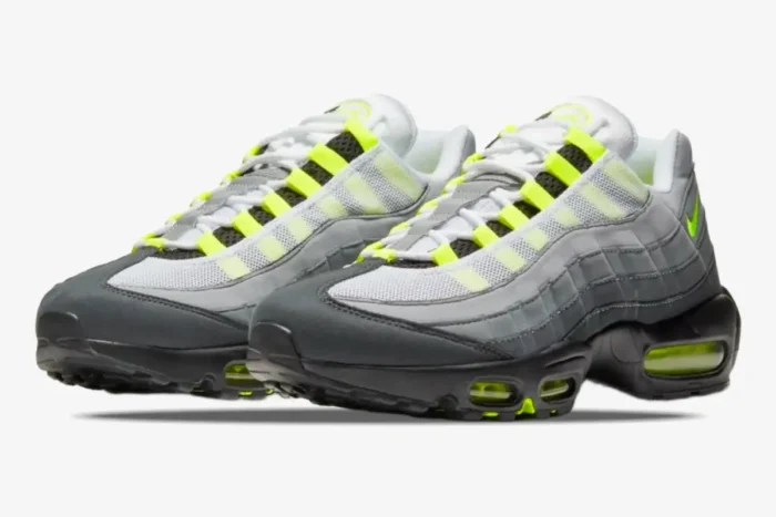 Three-quarter front view of Nike Air Max 95 OG sneakers in neon, grey, and black colors. - SKU 554970-071