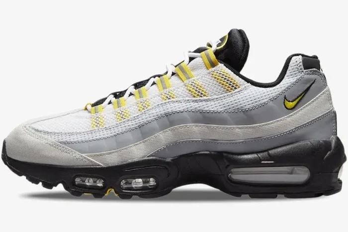 Side view of Nike Air Max 95 Tour sneakers featuring white mesh, grey panels, and yellow accents on a black sole. - SKU 609048-105