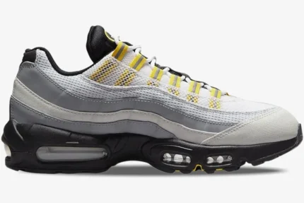 Side profile of Nike Air Max 95 Tour sneakers in white, grey, and yellow with visible air units. - SKU 609048-105