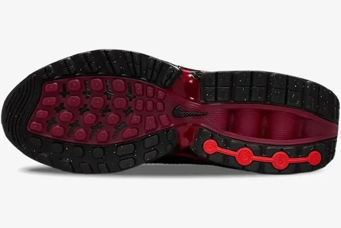 Bottom view of the Nike Air Max DN Bred in black and university red, showing the textured outsole pattern. - SKU HV5235-002