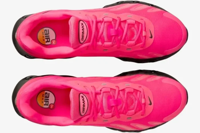 Top-down view of Nike Air Max Dn8 sneakers in vibrant hyper pink with black soles. - SKU FQ7860-600