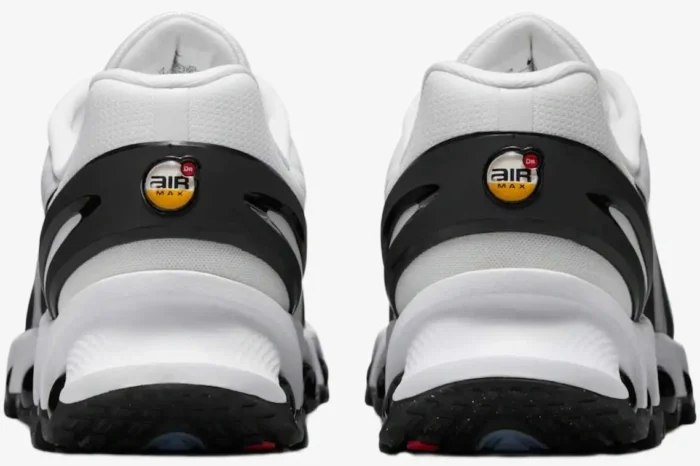 Rear view of Nike Air Max DN8 sneakers in white and black, showing the heel logo and textured sole. - SKU  FQ7860-100