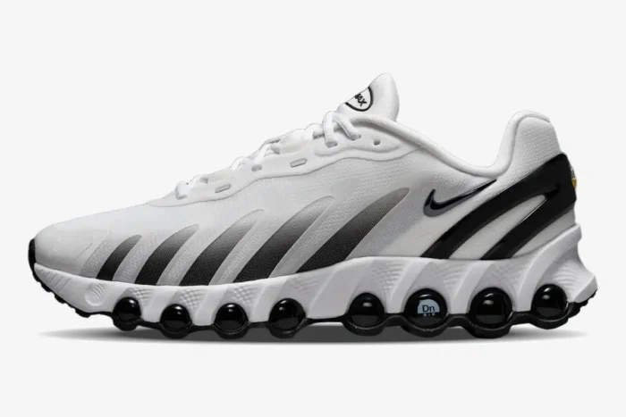 Nike Air Max DN8 sneaker in white and black, side profile view showing gradient stripes and circular air units. - SKU  FQ7860-100