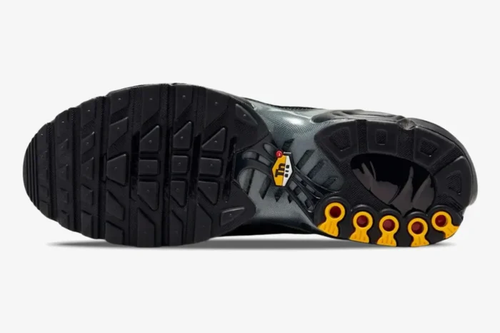 Bottom view of Nike Air Max Plus Black Reflective showing the black rubber outsole and yellow Tn Air logo. - SKU 604133-050