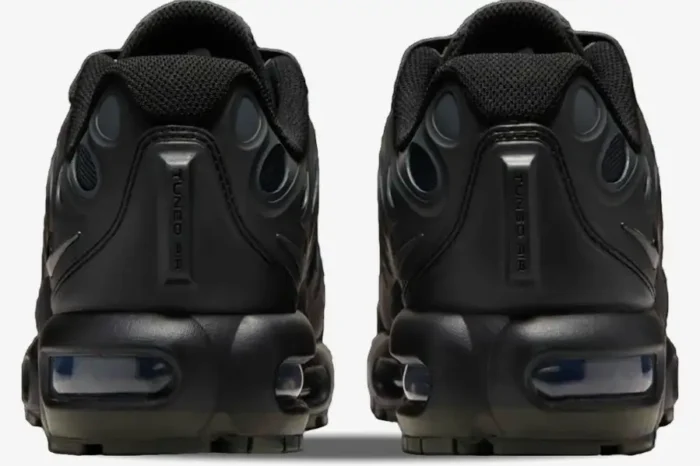 Rear view of Nike Air Max Plus Drift GS Triple Black sneakers showing heels and Air units. - SKU FV5921-002