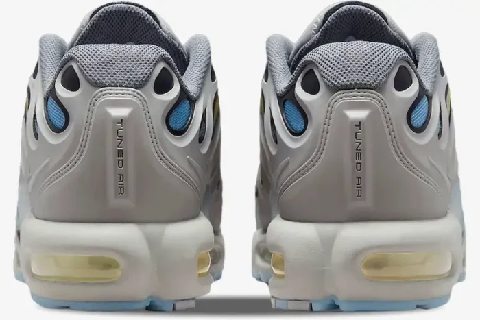 Rear view of Nike Air Max Plus Drift sneakers in smoke grey with blue accents and Tuned Air branding. - SKU FD4290-002