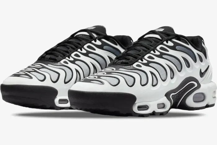 Nike Air Max Plus Drift sneakers in white and black, three-quarter front view. - SKU FV4081-102