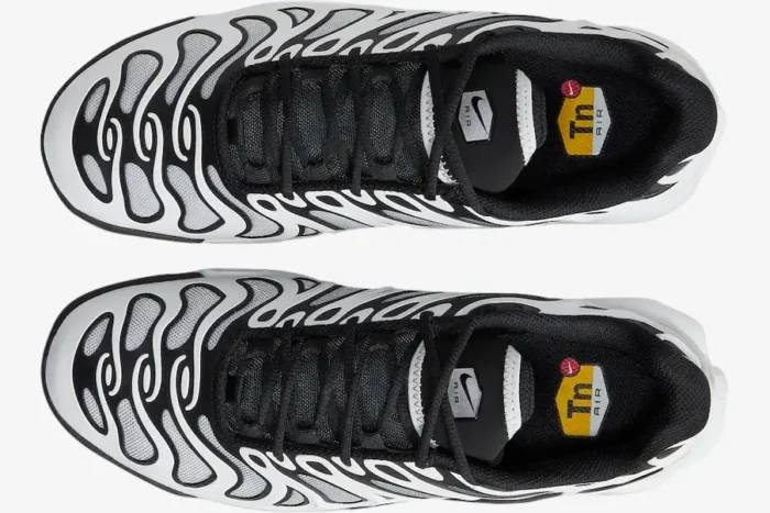 Top-down view of Nike Air Max Plus Drift shoes in white and black with wavy patterns and black laces. - SKU FV4081-102
