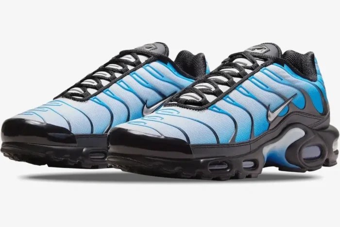 Nike Air Max Plus sneakers in gradient blue and white, three-quarter side view on a white background. - SKU FQ0204-010
