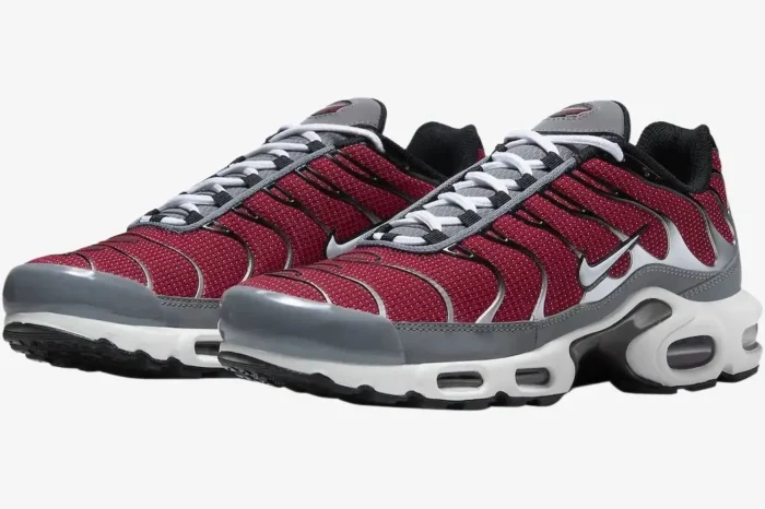 Nike Air Max Plus sneakers in red, grey, and white, shown from a three-quarter side perspective. - SKU DQ3983-600