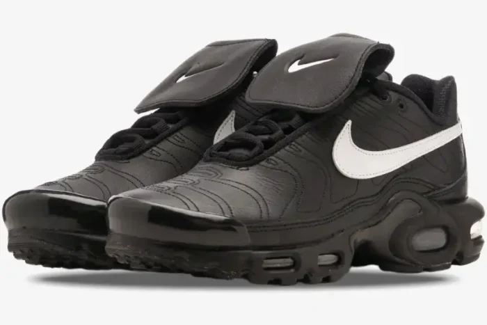 Nike Air Max Plus Tiempo hybrid sneakers in black leather with white swooshes, three-quarter front view. - SKU HF0074-001