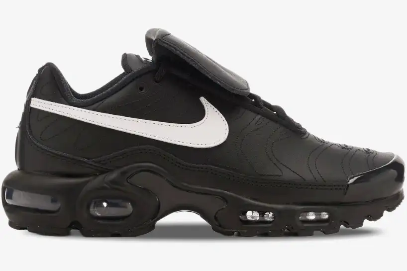 nike-air-max-plus-tiempo-black-white-side-view-hf0074-001 Side view of Nike Air Max Plus Tiempo hybrid sneakers in black leather with a white swoosh and visible air units. - SKU HF0074-001
