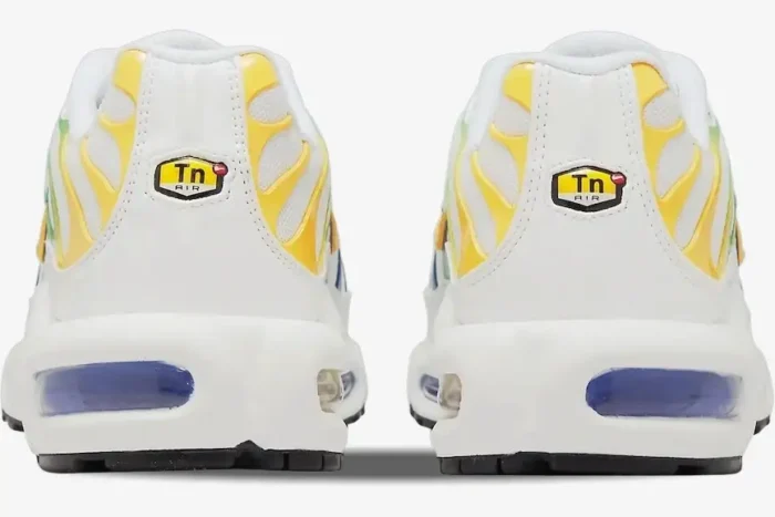 Rear view of white Nike Air Max Plus TN Brazil sneakers with yellow accents and blue air units. - SKU DZ3671-101