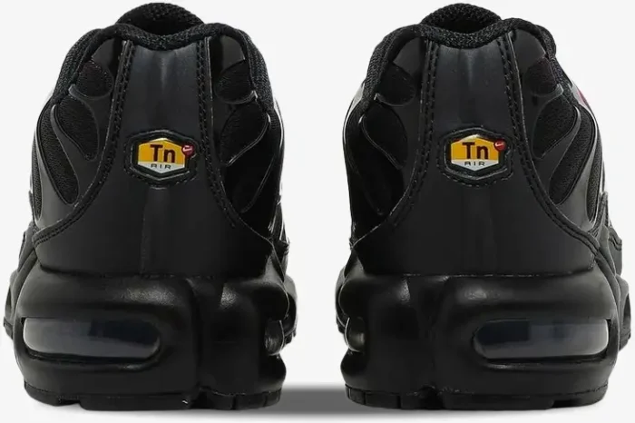 Rear view of black Nike Air Max Plus TN Deadpool sneakers with yellow Tn Air heel logos. - SKU DC1936-001
