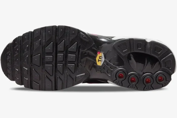 Bottom sole view of Nike Air Max Plus TN Dusk sneaker featuring black rubber tread and yellow TN logo. - SKU DZ3670-500