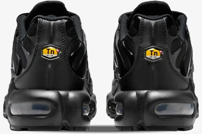 Rear view of Nike Air Max Plus TN Triple Black sneakers showing the heel logo and air units. - SKU DM2362-002