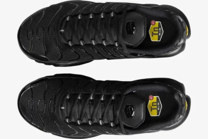 Top-down view of Nike Air Max Plus TN Triple Black sneakers featuring black mesh uppers and yellow Tn Air insole logos. - SKU DM2362-002