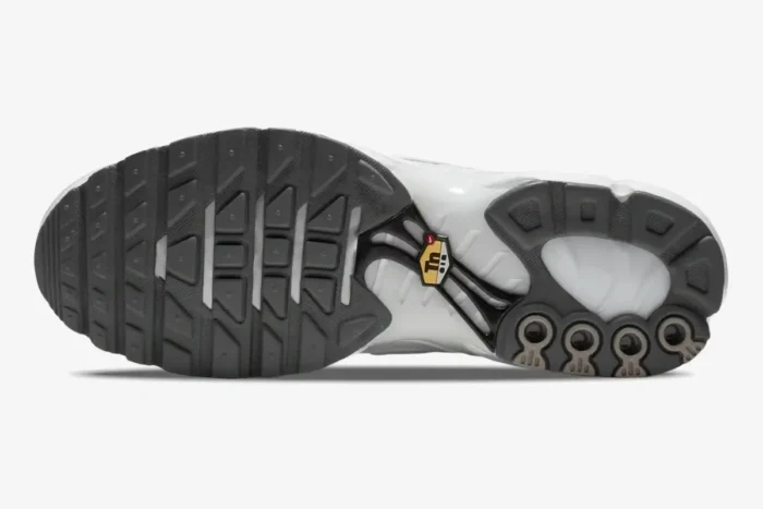 Bottom view of the Nike Air Max Plus Triple White outsole showing the grey tread pattern and Tn logo. - SKU 604133-139