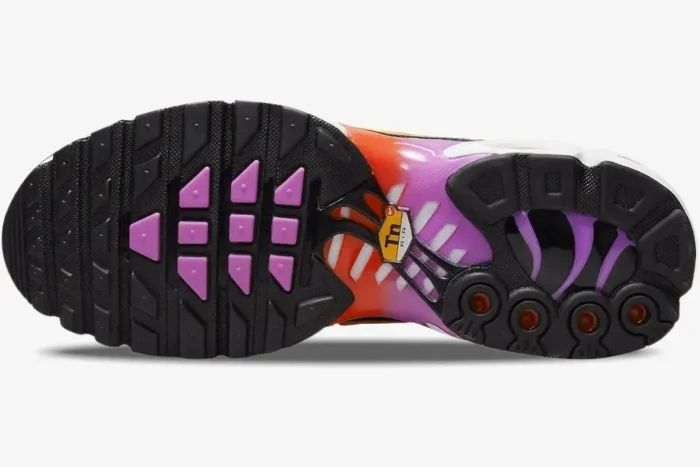 Bottom view of Nike Air Max Plus sole featuring black rubber, magenta accents, and a red-to-purple gradient shank. - SKU DZ3671-100
