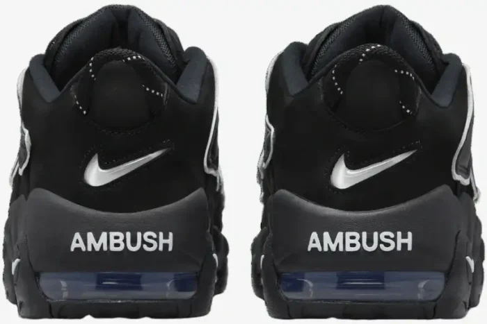 Rear view of black Nike Air More Uptempo Low x AMBUSH sneakers with white branding. - SKU FB1299-001