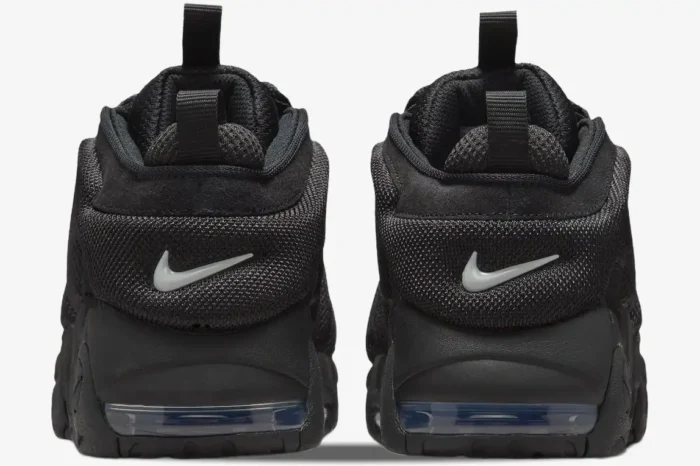 Rear view of Nike Air More Uptempo Low Triple Black sneakers with visible Air units and heel pull tabs. - SKU IM6649-001