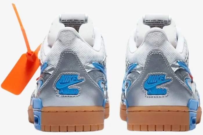 Rear view of Nike Air Rubber Dunk x Off-White University Blue sneakers with silver heels and gum soles. - SKU CU6015-100