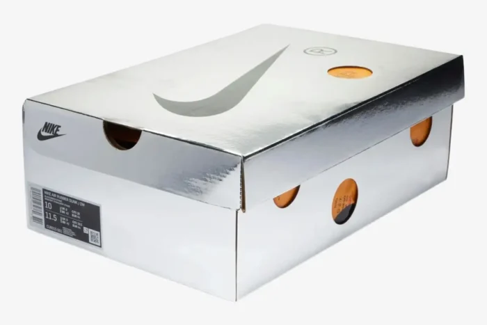 Silver metallic Nike Air Rubber Dunk x Off-White Green Strike shoebox with orange cutouts, three-quarter view. - SKU CU6015-001