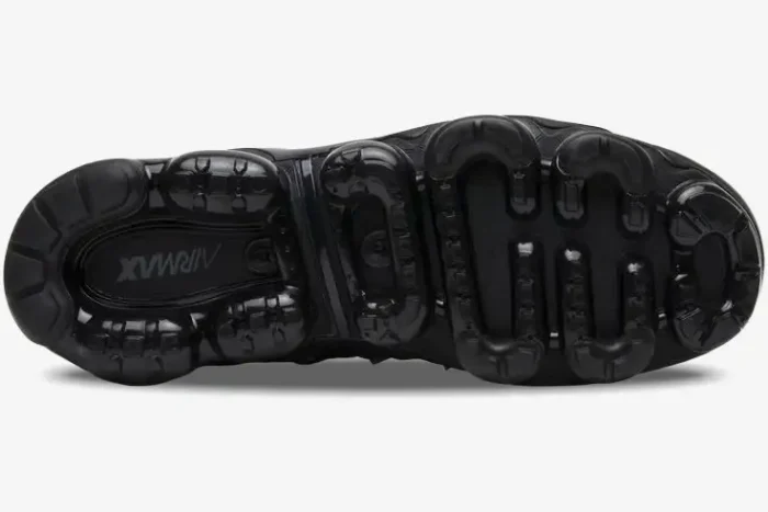 Bottom view of Nike Air Vapormax Plus Triple Black sneakers showing the signature air-cushioned outsole. - SKU 924453-004