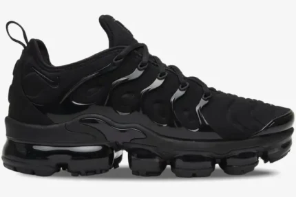 Side profile of the Nike Air Vapormax Plus in Triple Black with signature air pods. - SKU 924453-004