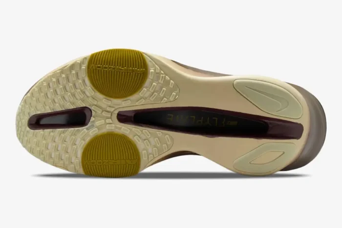 Bottom view of Nike Air Zoom Alphafly 3 Premium running shoe outsole in grey, gold, and brown. - SKU HV4318-320