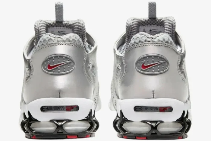 Rear view of Nike Air Zoom Spiridon Cage 2 in metallic silver with red swoosh and zoom air heel. - SKU CJ1288-001