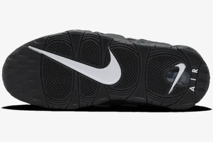 Bottom view of the Nike Air More Uptempo Low x AMBUSH Black White sneaker outsole with a large white swoosh. - SKU FB1299-001