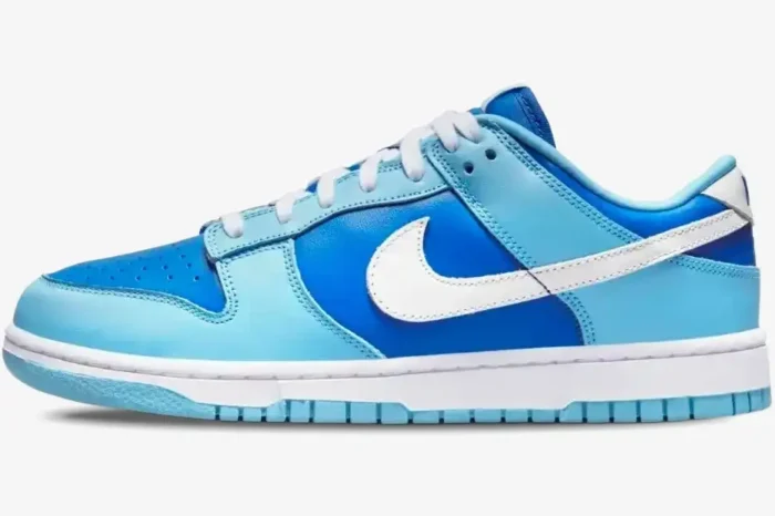 Side view of Nike Dunk Low Argon CO.JP Retro sneakers featuring light and dark blue leather panels. - SKU DM0121-400