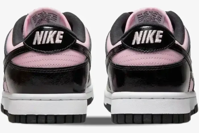 Back view of Nike Dunk Low Black Patent Pink women's sneakers with white Nike logo on black heel tabs. - SKU DJ9955-600