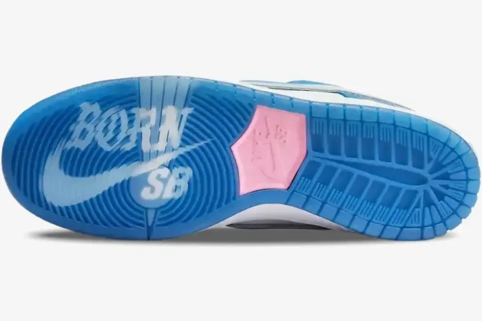 Bottom view of Nike Dunk Low x Born x Raised showing translucent blue outsole with pink logo and white graphics. - SKU FN7819-400