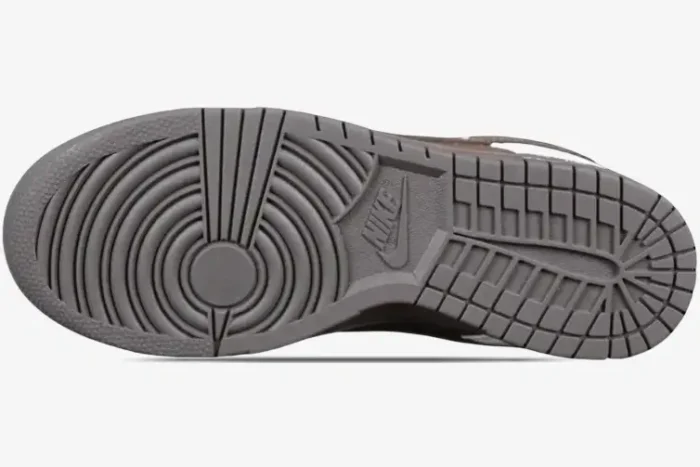 Bottom view of the brown rubber outsole of a Nike Dunk Low x Chrome Hearts Custom Brown White sneaker.