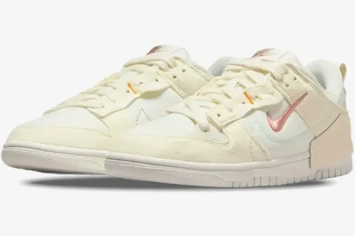 Nike Dunk Low Disrupt 2 Pale Ivory and Sail sneakers shown from a three-quarter front perspective. - SKU DH4402-101
