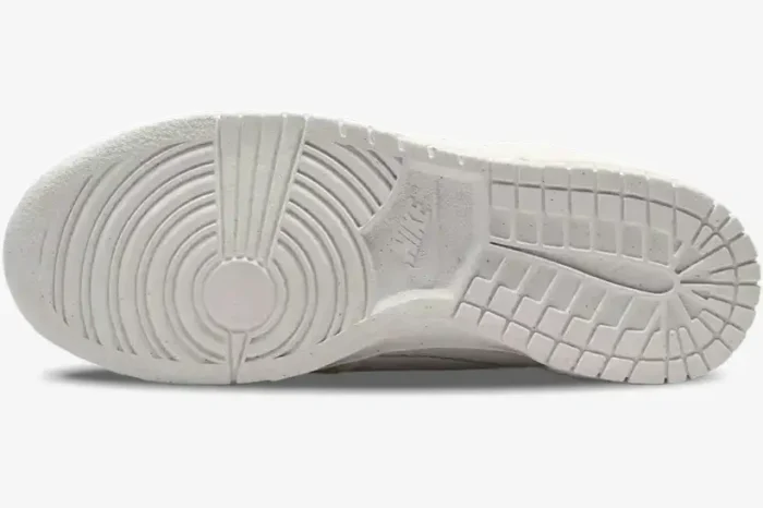 Bottom view of Nike Dunk Low Disrupt 2 Pale Ivory and Sail showing the textured rubber outsole pattern. - SKU DH4402-101