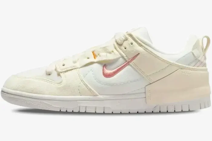 Side view of Nike Dunk Low Disrupt 2 in Pale Ivory and Sail with pink embroidered swoosh. - SKU DH4402-101