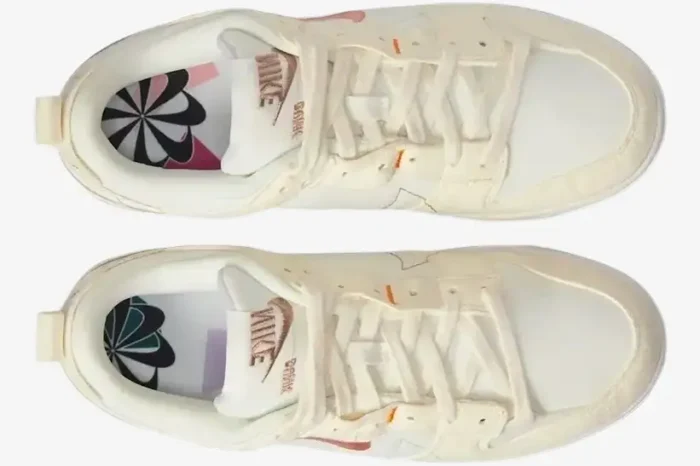 Top-down view of Nike Dunk Low Disrupt 2 sneakers in Pale Ivory and Sail with graphic insoles. - SKU DH4402-101