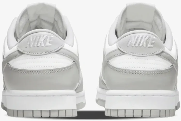 Rear view of Nike Dunk Low Grey Fog sneakers featuring white and grey leather panels and heel logos. - SKU DD1391-103