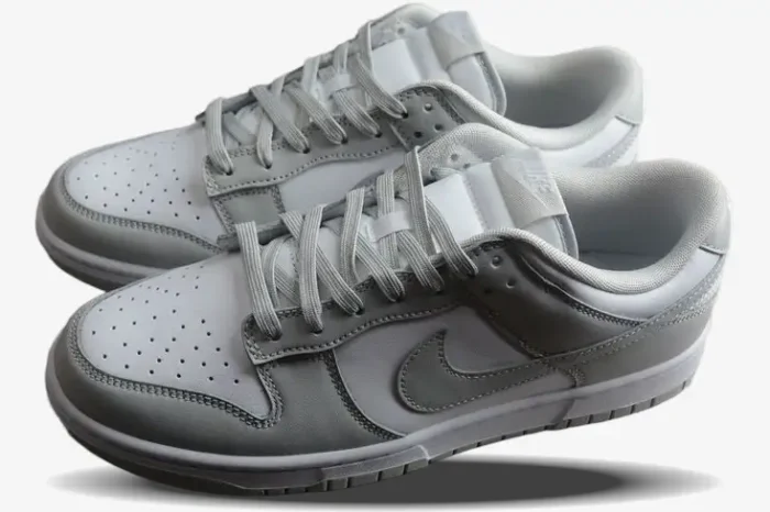 Pair of Nike Dunk Low Grey Fog sneakers in white and light grey, three-quarter side view on white background. - SKU DD1391-103