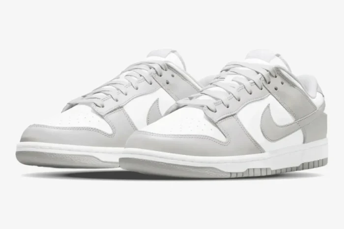 Nike Dunk Low Grey Fog sneakers in a three-quarter front view featuring white and light grey leather. - SKU DD1391-103