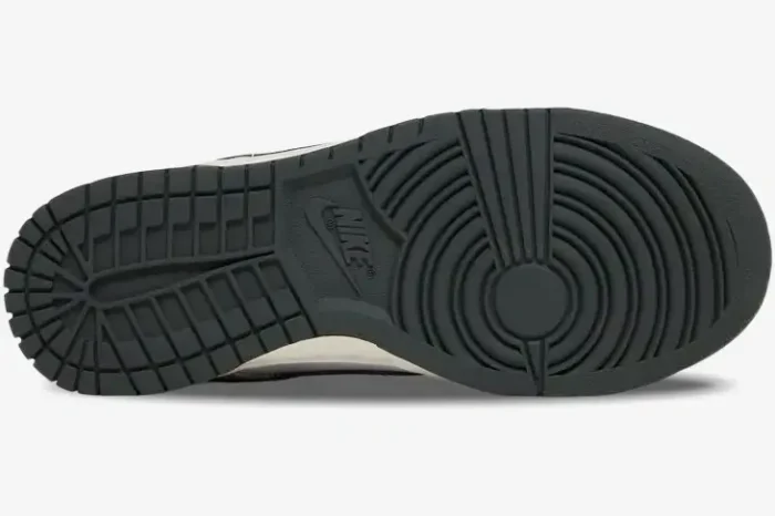 Bottom outsole view of Nike Dunk Low Light Smoke Grey sneakers showing dark grey traction pattern. - SKU DD1503-117