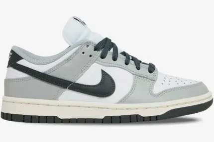 Nike Dunk Low Light Smoke Grey sneakers in a side profile view featuring white, grey, and black panels. - SKU DD1503-117