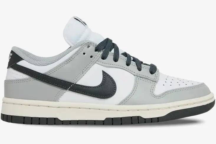nike-dunk-low-light-smoke-grey-side-view-dd1503-117 Nike Dunk Low Light Smoke Grey sneakers in a side profile view featuring white, grey, and black panels. - SKU DD1503-117