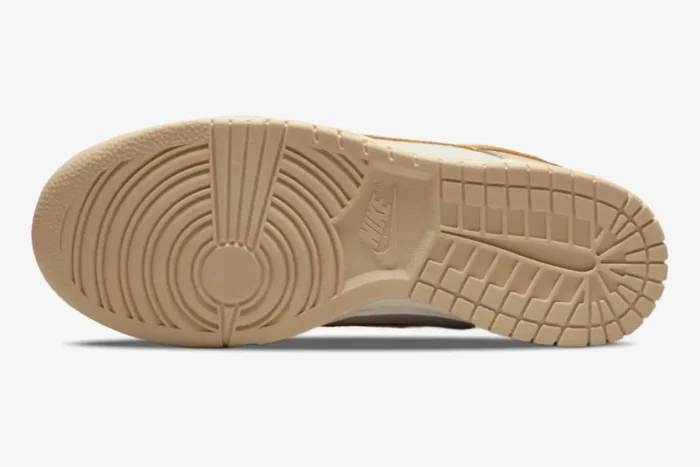 Bottom view of the Nike Dunk Low Essential Trend Phantom Metallic Gold women's sneaker outsole. - SKU DX5930-001